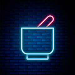 Glowing neon line Mortar and pestle icon isolated on brick wall background. Colorful outline concept. Vector
