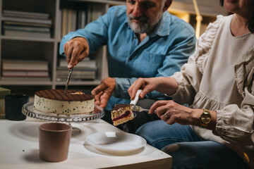 middle age couple having cake for desert at home