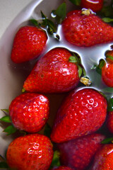 Plate full with strawberries in water