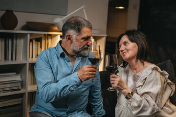 middle age couple drinking wine at home