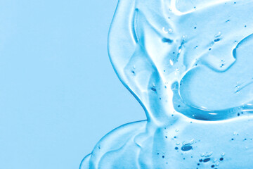 Transparent hyaluronic acid gel on a blue background. Copy space for text.