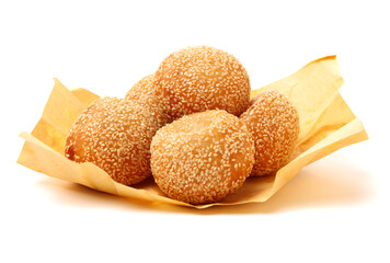 Golden fried dessert balls covered with sesame on white background