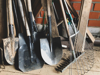 Garden tools in the barn, shovels, rakes.