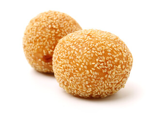 Golden fried dessert balls covered with sesame on white background