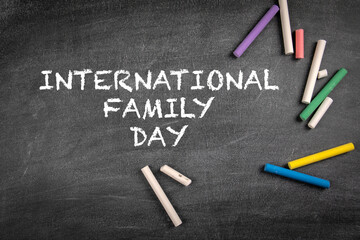 Fototapeta na wymiar International Family Day on 15 May. Black chalk board with chalk pieces