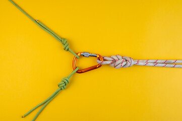 Orange Carabiner with rope. Equipment for climbing and mountaineering, alpinism, rappelling. Safety...