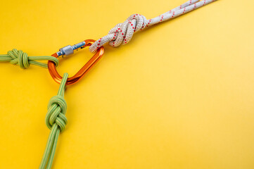 Orange Carabiner with rope. Equipment for climbing and mountaineering, alpinism, rappelling. Safety...