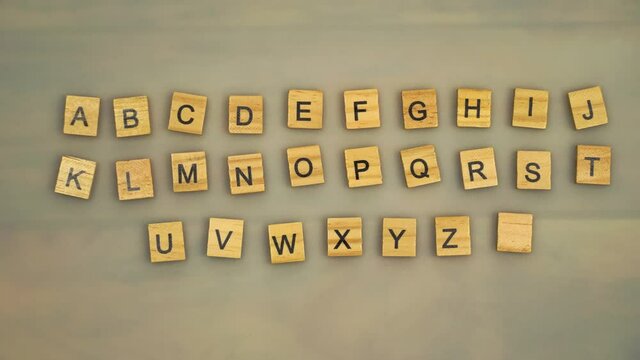 The letters of the alphabet on the wooden cubes move around the table creating an alphabet from A to Z, then dance synchronously creating a movement.