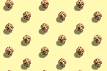 The whole unpeeled walnuts pattern on yellow background