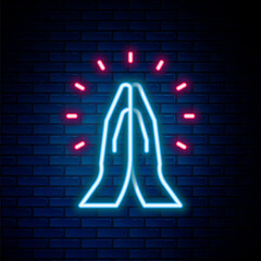 Glowing neon line Hands in praying position icon isolated on brick wall background. Prayer to god with faith and hope. Colorful outline concept. Vector