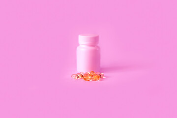 vitamin capsules on a pink background