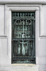 Weathered and worn closed copper mausoleum door