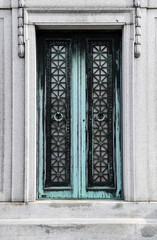 Fototapeta na wymiar Weathered and worn closed copper mausoleum door