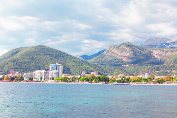 View from the sea to the Budva City in Montenegro . Adiatic Sea and Balkans scenery . Coastal city in Montenegro with resorts and hotels
