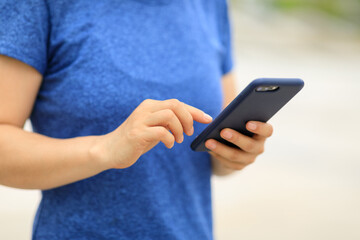 Asian woman using smartphone outdoors