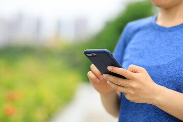 Asian woman using smartphone outdoors