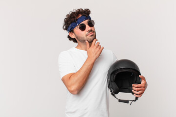 motorbike rider thinking, feeling doubtful and confused, with different options, wondering which...
