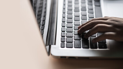 Hand holding push on keyboard, Type a message, Use of laptop equipment for work.