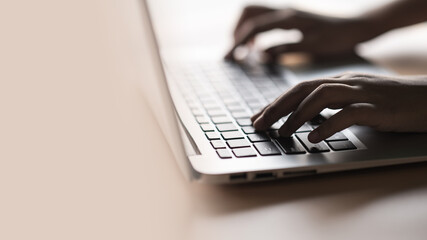 Hand holding push on keyboard, Type a message, Use of laptop equipment for work.