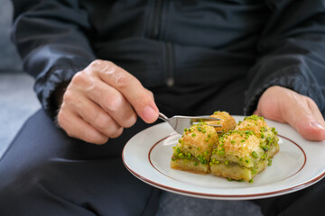The man is eating baklava.