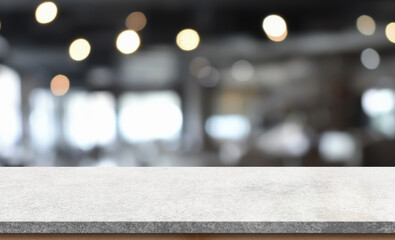 Empty white marble stone table top and blur interior cafe and restaurant.