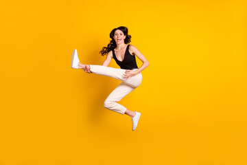 Fototapeta na wymiar Full length body size photo of woman imagine she is rock star on stage jumping isolated vibrant yellow color background