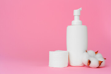 Stack of cotton discs and skicare cosmetic bottle