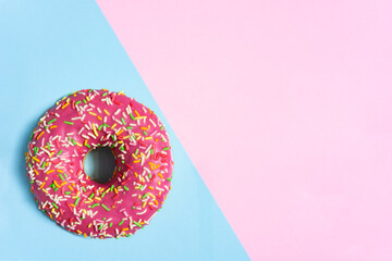 Creative food diet concept photo of donut bite on pink blue background.