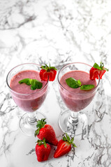 Strawberry banana smoothie. Strawberry dessert. Light gray background. Place for you text.