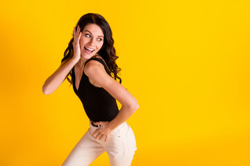 Obraz premium Photo of young cheerful girl happy positive smile look empty space gorgeous fancy isolated over yellow color background