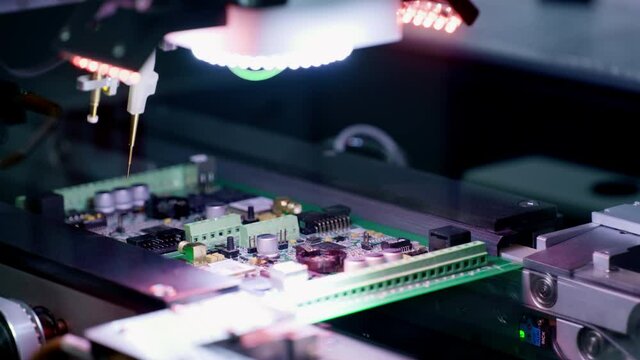Production of electronic circuit boards. Machine for automatic installation of components on an electronic board. Manufacturing of microcircuits and microprocessors. The transistors are installed.