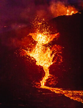 Lava exploding in from the volcano, red fire erupting from the crater in Iceland