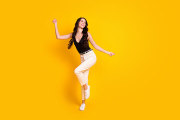 Fototapeta na wymiar Full size photo of young cheerful girl happy positive smile have fun look empty space isolated over yellow color background