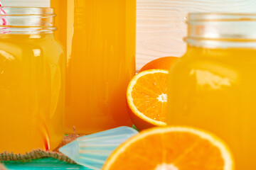 Glass with orange juice on green wooden table