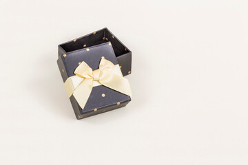 opened black gift box with dots and ribbon