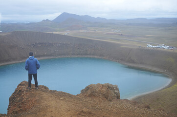 person on the edge of the mountain, lake