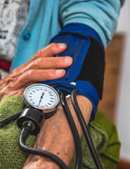 Measuring the pressure of an old woman at home. Help at home
