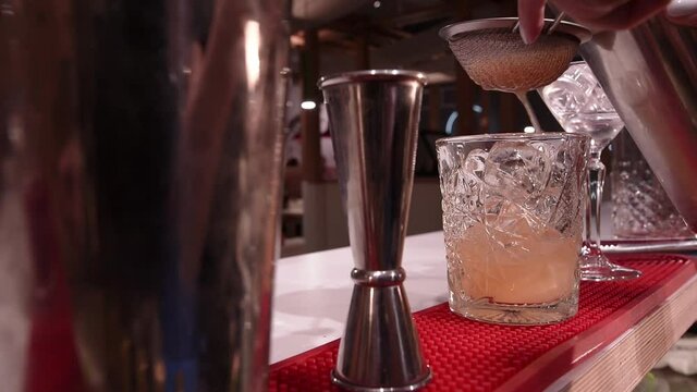 professional bartender makes a cocktail in a nightclub. shaker. 