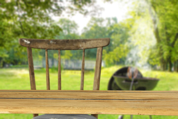 Fototapeta premium Wooden desk of free space and grill time in garden 