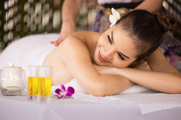 Obraz na płótnie Canvas Beautiful young asian girl resting relaxing oil massage in spa resort with closed eyes.