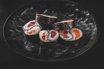 Yin yang sushi roll with tuna and salmon on plate