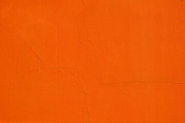 Fresh orange paint on a plastered wall