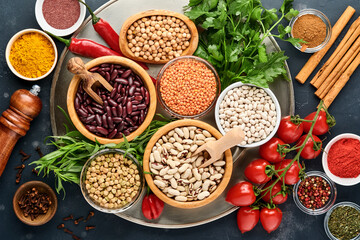 Legumes, lentils, chickpea, beans assortment, tasty appetizing ingredients spices grocery for...