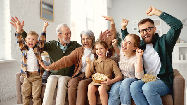 Happy Big Family Celebrating Goal While Watching Football Match On Tv