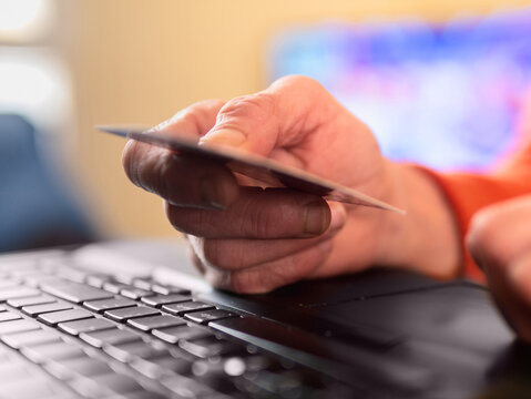 Person pays with a credit card online.