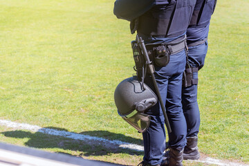 Two riot police at a soccer field