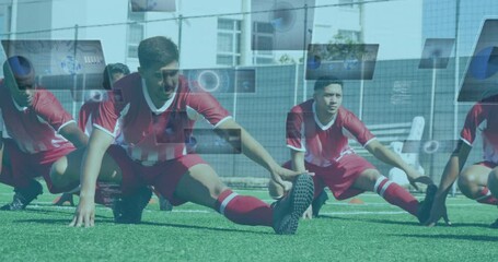 Animation of scopes and data processing on screens over male football players stretching - Powered by Adobe
