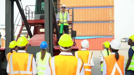 Foreman manager standing on forklift Fire fighting demonstration  how to use a fire extinguisher to Containers worker at warehouse logistic in Cargo freight ship port