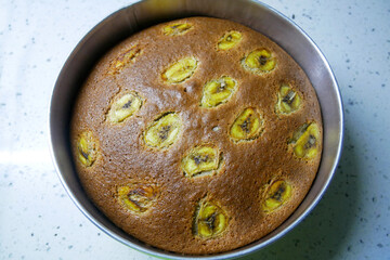 Banana cake is freshly cooked and will be served. Decorated with slices of banana on top.