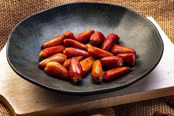 Pine nuts cooked inside a rustic ceramic dish. Typical winter food in southern Brazil. They are the seeds of the fruit of an Araucaria and widely used in Brazilian gastronomy.